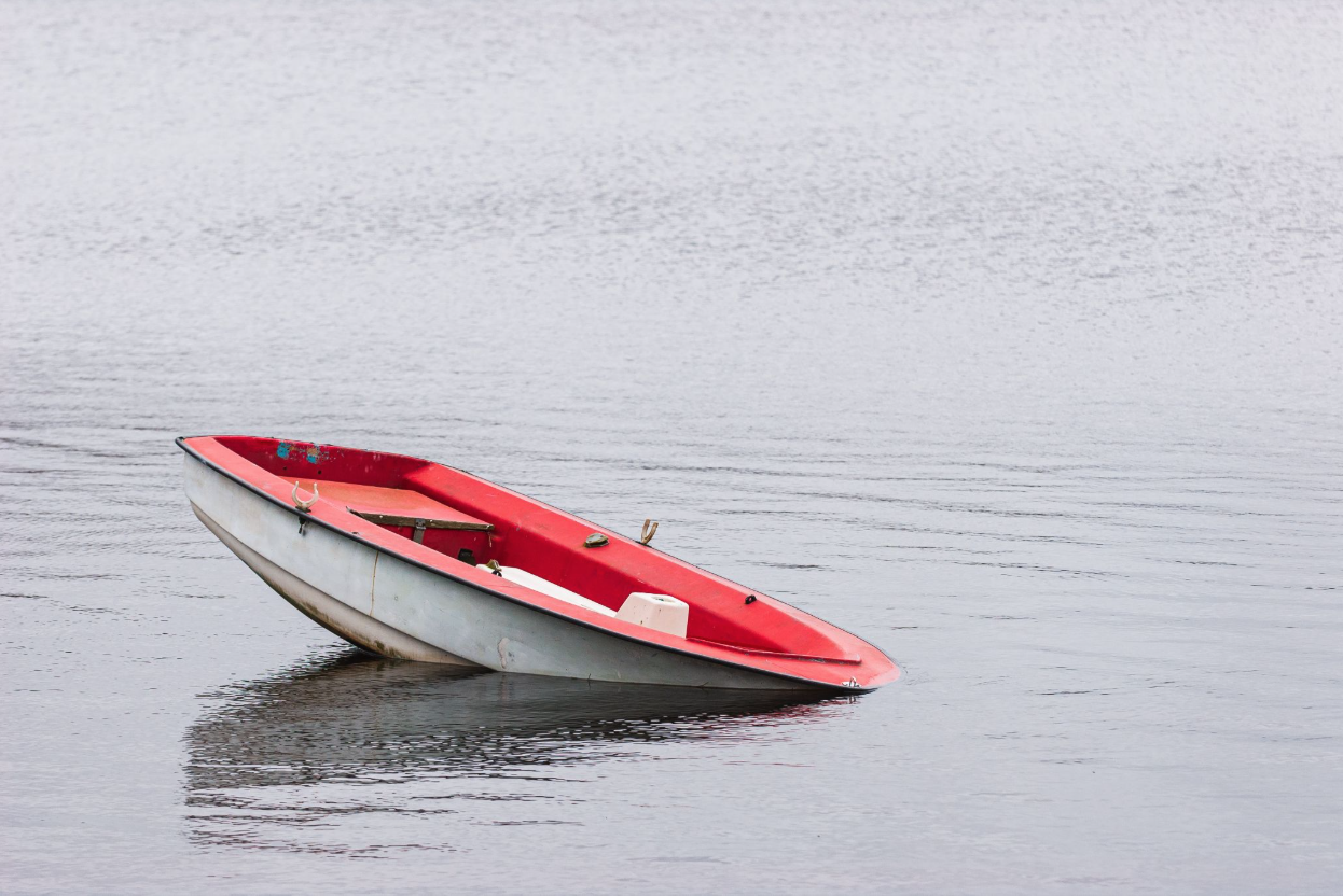 A sinking boat in water.