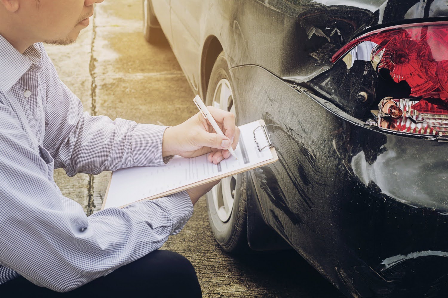 Insurance agent working on car accident claim process.